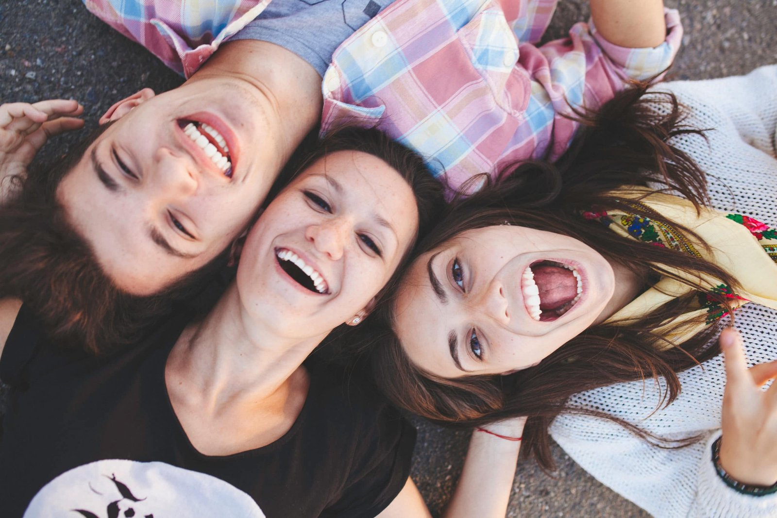 friends lying down and laughing
