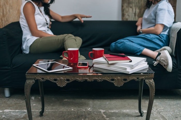 women talking on couch